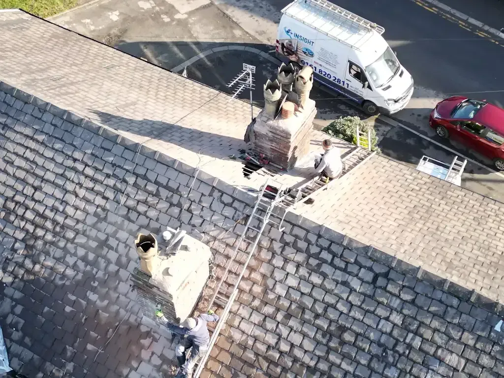Insight PS roofers repairing chimneys on a tiled roof in Manchester