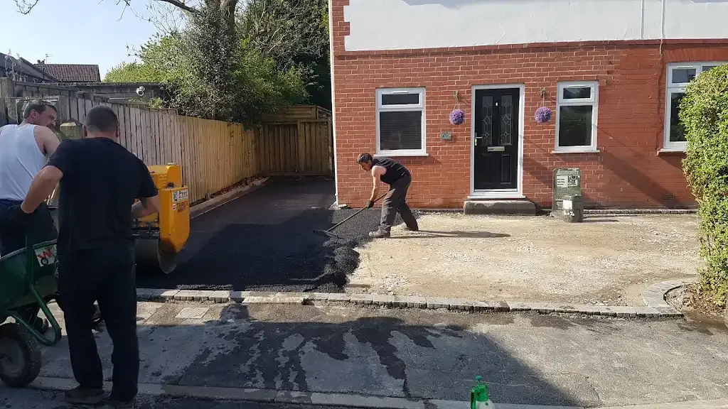 Professional team installing a new tarmac driveway for a house
