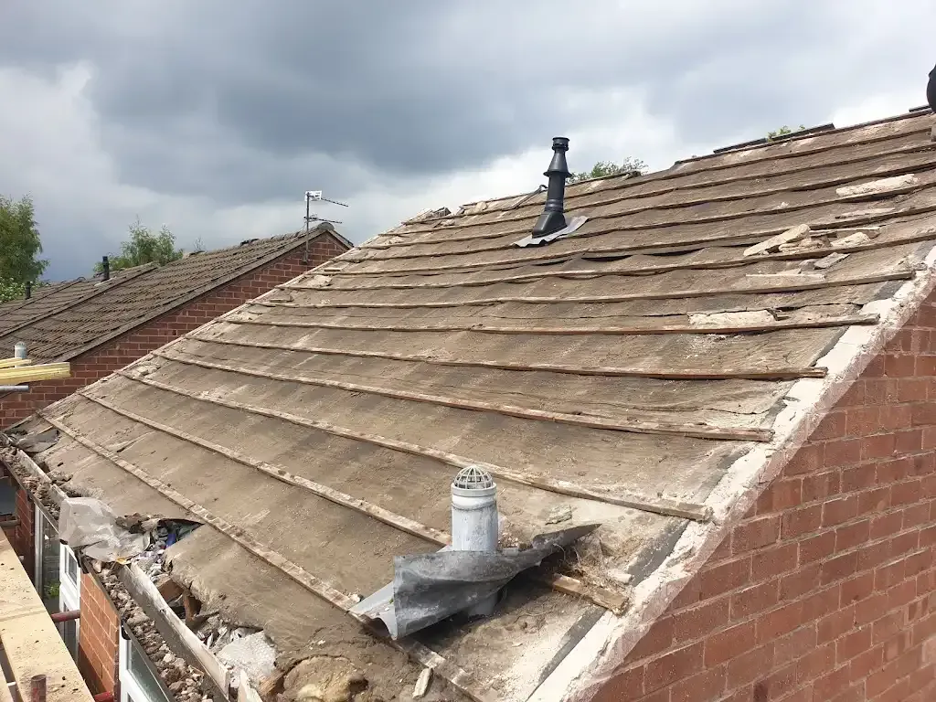 A picture of a damaged tiled roof in need of repair.